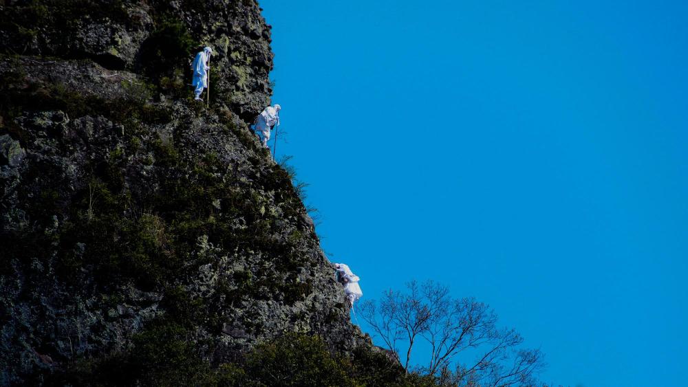 Pilgrims descending the steep mountainside